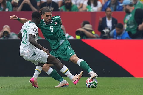Iraq's Akam Hashim (5) moves the ball past Senegal's Habib Diarra (21) during the World Cup Group I soccer match between Senegal and Iraq in Toronto, Friday, June 26, 2026.