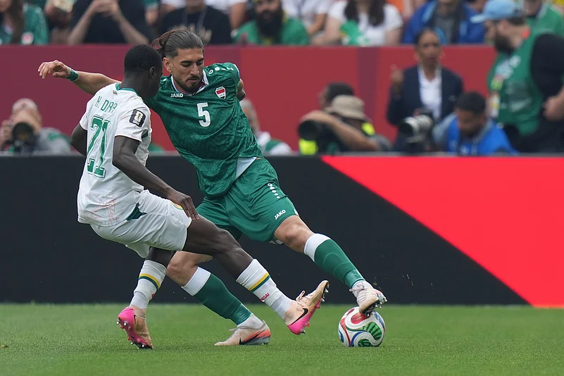 Iraqs Akam Hashim (5) moves the ball past Senegals Habib Diarra (21) during the World Cup Group I soccer match between Senegal and Iraq in Toronto, Friday, June 26, 2026.