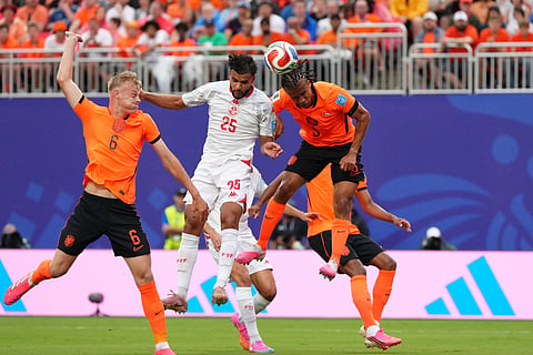 Tunisia's Anis Slimane jumps for the ball with Netherlands' Nathan Ake, right, and Jan Paul van Hecke during the World Cup Group F soccer match between Tunisia and the Netherlands in Kansas City, Mo., Thursday, June 25, 2026.