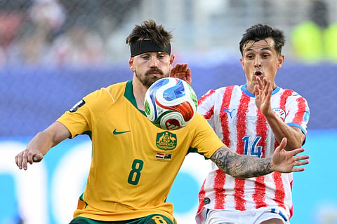 Australia's Connor Metcalfe (8) battles for the ball with Paraguay's Andres Cubas (14) during the World Cup Group D soccer match between Paraguay and Australia in Santa Clara, Calif., near San Francisco, Thursday, June 25, 2026.