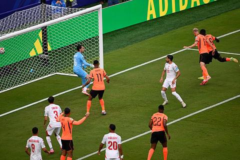 Netherlands' Brian Brobbey, far right, scores their second goal past Tunisia goalkeeper Aymen Dahmen (16) during the World Cup Group F soccer match between Tunisia and the Netherlands in Kansas City, Mo., Thursday, June 25, 2026.