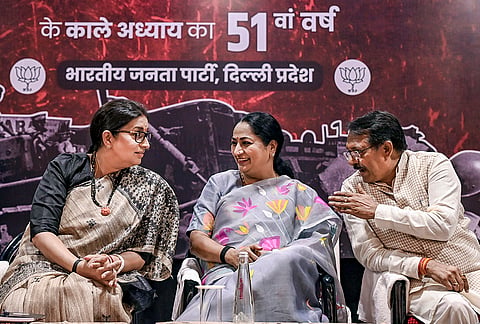 Delhi Chief Minister Rekha Gupta, centre, along with Delhi BJP state president Harsh Malhotra, right, and BJP leader Smriti Irani during a seminar on 'Black Emergency Day' at NDMC Convention Center, in New Delhi.