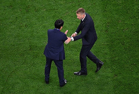 Japan head coach Hajime Moriyasu, left, shakes hands with Sweden head coach Graham Potter after the World Cup Group F soccer match between Japan and Sweden in Arlington, Texas, near Dallas.