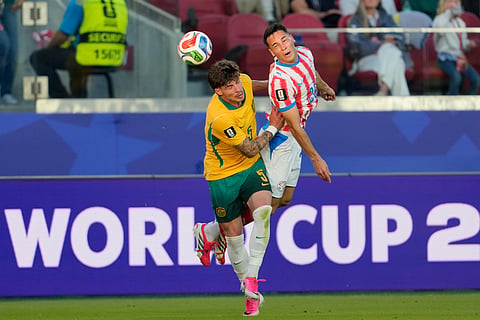 Paraguay's Alexandro Maidana (26) battles for a header with Australia's Jordan Bos (5) during the World Cup Group D soccer match between Paraguay and Australia in Santa Clara, Calif., near San Francisco, Thursday, June 25, 2026.