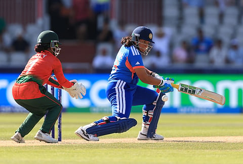 India's Richa Ghosh, right, during the ICC Women's T20 World Cup cricket match between India and Bangladesh in Manchester, England.