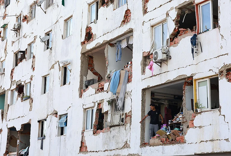 A resident stands in a damaged building a day after an earthquake struck La Guaira, Venezuela. - | Photo: AP/Javier Campos