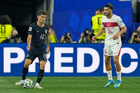 United States' Christian Pulisic (10) and Turkey's Oguz Aydin (24) compete for the ball during the World Cup Group D soccer match between Turkey and the United States in Inglewood, Calif., near Los Angeles, Thursday, June 25, 2026.