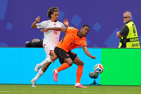 Tunisia's Hannibal Mejbri, left, vies for the ball with Netherlands' Ryan Gravenberch during the World Cup Group F soccer match between Tunisia and the Netherlands in Kansas City, Mo., Thursday, June 25, 2026.