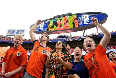 Netherlands fans celebrate a win during the World Cup Group F soccer match between Tunisia and the Netherlands in Kansas City, Missouri.
