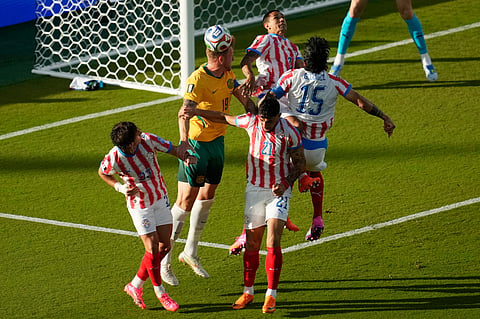 Australia's Harry Souttar (19) heads the ball against Paraguay's Matias Galarza (23), Gustavo Velazquez (2), Gustavo Gomez (15) and Gabriel Avalos (21) during the World Cup Group D soccer match between Paraguay and Australia in Santa Clara, Calif., near San Francisco, Thursday, June 25, 2026.