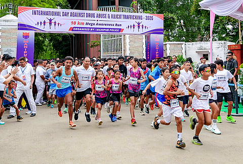 Manipur Chief Minister Yumnam Khemchand Singh, unseen, flags off a ten kilometer run from the Western Gate of Kangla on the occasion of International Day Against Drug Abuse, in Imphal, Manipur. 