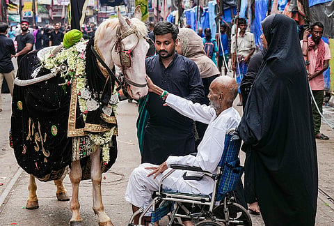 People accompany the symbolic Duldul horse during a procession on the occasion of Muharram, in Kolkata, West Bengal.