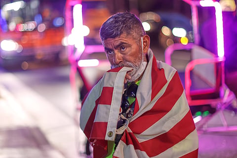 A fan draped in an American flag watches the World Cup Group D soccer match between Turkey and the United States in Inglewood, Calif., near Los Angeles, Thursday, June 25, 2026.