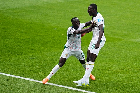 Senegal's Pape Gueye (26) celebrates with Sadio Mane after scoring the team's third goal during the World Cup Group I soccer match between Senegal and Iraq in Toronto, Friday, June 26, 2026.