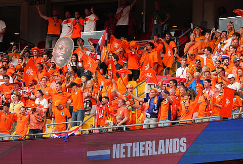 Netherlands fans celebrate at the end of the World Cup Group F soccer match between Tunisia and the Netherlands in Kansas City, Missouri.