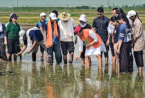 Union Agriculture and Farmers Welfare Minister Shivraj Singh Chouhan plants paddy saplings along with the students of Govind Ballabh Pant University of Agriculture and Technology (GBPUAT) during an interaction, in Udham Singh Nagar district, Uttarakhand.