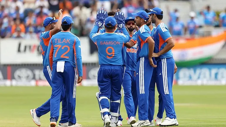The Indian players celebrate an early wicket in just the second over of the game - AP