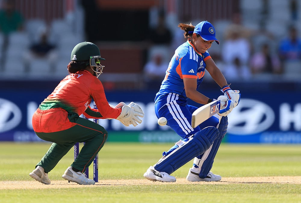 India's Harmanpreet Kaur, right,during the ICC Women's T20 World Cup cricket match between India and Bangladesh in Manchester, England. - | Photo: Nigel French/PA via AP