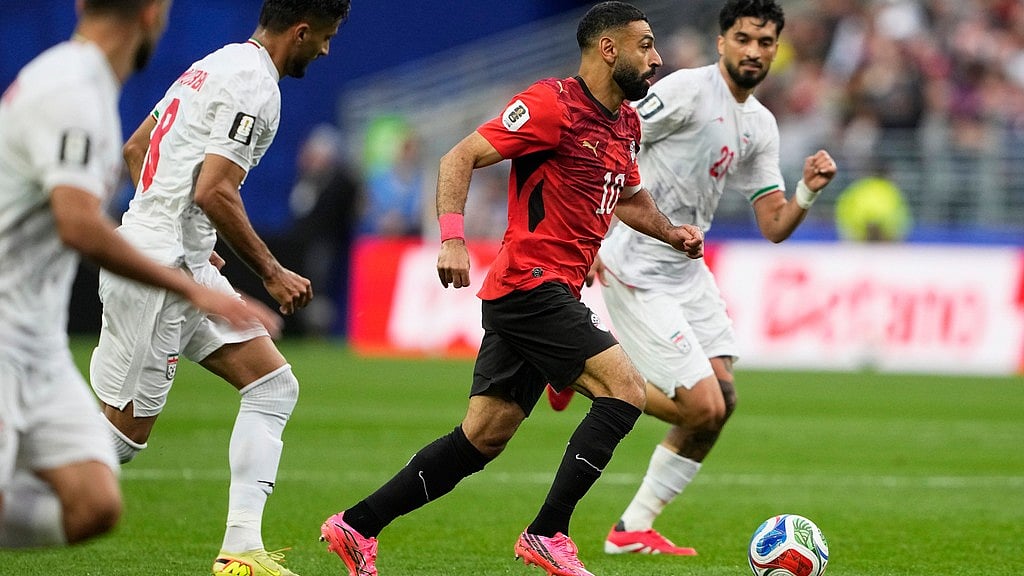 Egypt's Mohamed Salah (10) battles for the ball with Iran's Mohammad Ghorbani (21), right, and Iran's Mohammad Mohebbi (8) during the World Cup Group G soccer match between Egypt and Iran in Seattle, Friday, June 26, 2026. - AP Photo/Lindsey Wasson