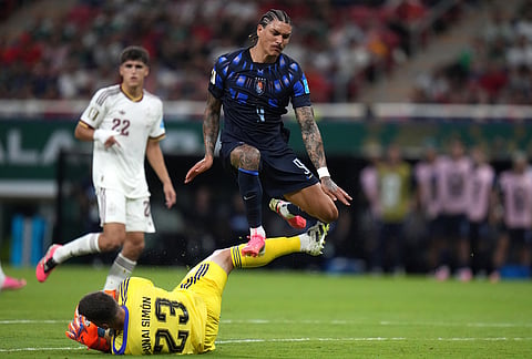 Spain goalkeeper Unai Simon (23) makes a save against Uruguay's Darwin Nunez (9) during the World Cup Group H soccer match between Uruguay and Spain in Zapopan, near Guadalajara, Mexico.
