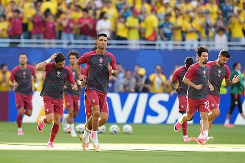 Portugal's Cristiano Ronaldo (7), center, warms-up before the World Cup Group K soccer match between Colombia and Portugal in Miami Gardens