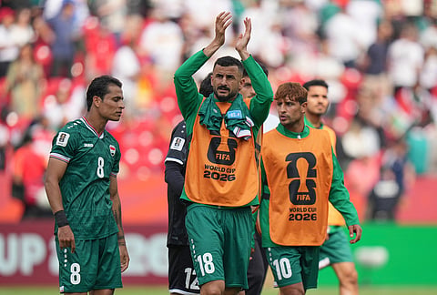 Iraq's Aymen Hussein (18) applauds supporters as they leave the pitch after their loss in the World Cup Group I soccer match between Senegal and Iraq in Toronto.
