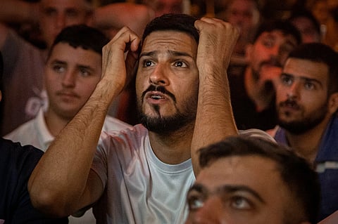Soccer fans watch the World Cup Group I match between Senegal and Iraq at an outdoor cafe in downtown Baghdad, Iraq.