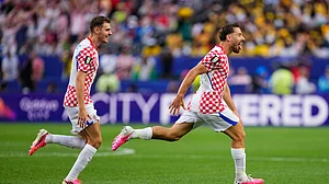 (AP Photo/Petr Josek) : Croatias Nikola Vlasic (13) celebrates after scoring his sides second goal during the World Cup Group L soccer match between Croatia and Ghana in Philadelphia, Saturday, June 27, 2026.