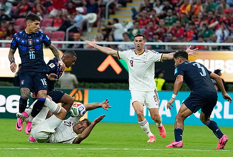 Uruguay's Mathias Olivera, left, challenges for the ball with Spain's Mikel Oyarzabal, down, during the World Cup Group H soccer match between Uruguay and Spain in Zapopan, near Guadalajara, Mexico.