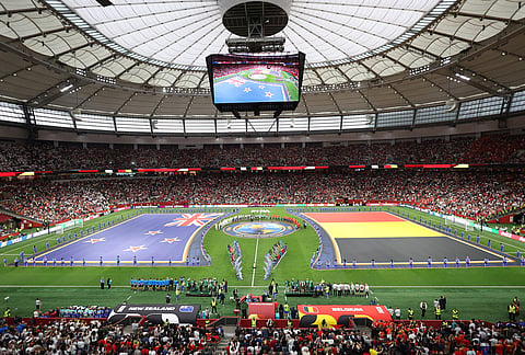 The New Zealand and Belgium teams stand at the center of the pitch during opening ceremonies for their World Cup Group G soccer match in Vancouver, British Columbia.
