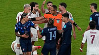 AP Photo/Fernando Llano : In frame, Ismail Elfath stopping a fight between the Spanish and the Uruguayan players in their group H clash 