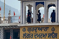 PTI : 'Nihangs' stand on the roof of a gurdwara to demand the release of four members of the Sikh sect who were arrested following a clash in Chamoli district, in Rudraprayag, Uttarakhand, Sunday, June 21, 2026. 