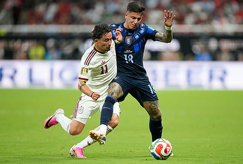 Spain's Yeremy Pino, left, and Uruguay's Brian Rodriguez battle for the ball during the World Cup Group H soccer match between Uruguay and Spain in Zapopan, near Guadalajara, Mexico.
