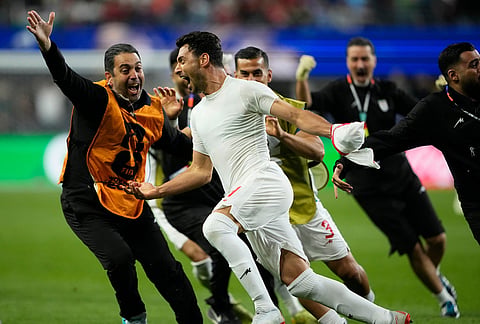 Iran's Shoja Khalilzadeh (4) celebrates after scoring a goal before it was overturned following a VAR review during the World Cup Group G soccer match between Egypt and Iran in Seattle.