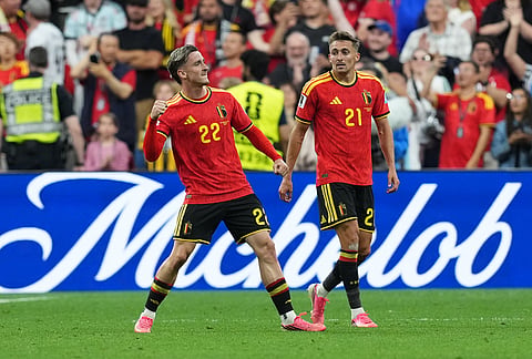 Belgium's Alexis Saelemaekers (22) celebrates his goal with Belgium's Timothy Castagne (21) during the second half of a World Cup Group D soccer match, in Vancouver, British Columbia.