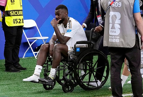Saudi Arabia's Hassan Altambakti is wheeled off the pitch after the first half of the World Cup Group H soccer match between Cape Verde and Saudi Arabia in Houston.