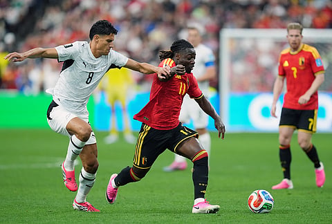 New Zealand's Marko Stamenic (8) and Belgium's Jeremy Doku (11) vie for the ball during the first half of a World Cup Group D soccer match, in Vancouver, British Columbia.