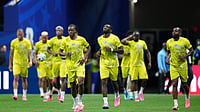 (AP Photo/Jacob Kupferman) : Congo players arrive on the pitch to warm up prior to the World Cup Group K soccer match between DR Congo and Uzbekistan in Atlanta, Saturday, June 27, 2026.