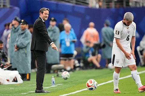 Panama head coach Thomas Christiansen, left, instructs players from the sidelines during the World Cup Group L soccer match against England in East Rutherford