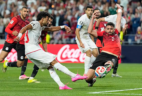 Egypt's Yasser Ibrahim (2) stops a shot from Iran's Ramin Rezaeian (23) during the World Cup Group G soccer match between Egypt and Iran in Seattle.