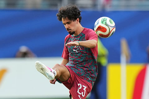 Portugal's Vitinha (23) kicks the ball as he warms-up before the World Cup Group K soccer match between Colombia and Portugal in Miami Gardens