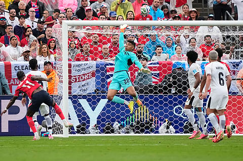 Panama goalkeeper Orlando Mosquera, center, jumps to make a save during the World Cup Group L soccer match against England in East Rutherford