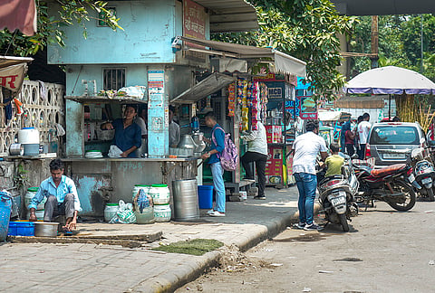 Roadside kiosks and commercial activity occupy a footpath, obstructing pedestrian movement, at Wazirpur, in New Delhi. The Supreme Court has held that the right to walk on a demarcated footpath is a fundamental right. 