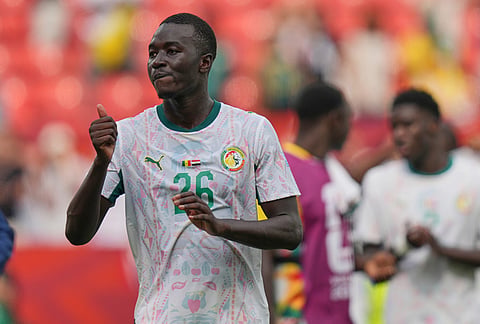 Senegal's Pape Gueye (26) gives a thumbs up as he walks off the pitch after their win in the World Cup Group I soccer match between Senegal and Iraq in Toronto.