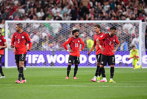 Egypt players react after Iran's Shoja Khalilzadeh scored a goal, which was later overturned as an offside, during the World Cup Group G soccer match between Egypt and Iran in Seattle.
