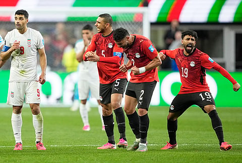 Egypt's Ramy Rabia (5), Yasser Ibrahim (2) and Marawan Attia (19) celebrate after Iran's Shoja Khalilzadeh's goal was overturned following a VAR review during the World Cup Group G soccer match between Egypt and Iran in Seattle.
