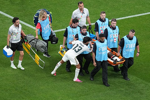 Saudi Arabia's Nawaf Bu Washl (13) consoles teammate Hassan Altambakti (5) while Altambakti is taken off the pitch on a stretcher during the World Cup Group H soccer match between Cape Verde and Saudi Arabia in Houston, Friday, June 26, 2026.