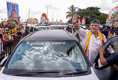 Karnataka Chief Minister DK Shivakumar greets the gathering during a mega plantation drive to plant 15 lakh saplings across Bengaluru to restore the city's green cover, at Kempegowda Layout on the occasion of Kempegowda's 517th birth anniversary, in Bengaluru.