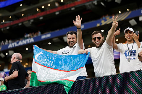 Uzbekistan supporters hold flags before the World Cup Group K soccer match between DR Congo and Uzbekistan in Atlanta, Saturday, June 27, 2026.