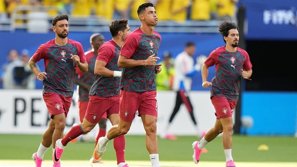 Portugal's Cristiano Ronaldo (7), center, warms-up before the World Cup Group K soccer match between Colombia and Portugal in Miami Gardens. - Lynne Sladky/AP Photo